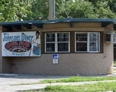 Circa 1983. Started by Mrs. L. Johnson on the corner of Parramore and Robinson in “The Heart of Callahan”, Johnson's menu included homemade biscuits, peach cobbler, pork chops, catfish, meatloaf, collard greens, oxtail cornbread, sweet potato pie (sold by the slice for $1.50). A different menu was served each day. The diner moved to the City View complex at 595 West Church Street in 2006. Through the years, Johnson’s Diner grew into one of Parramore’s iconic southern soul food restaurant that served the locals, politicians, and professional athletes. Johnson’s Diner closed in 2010.